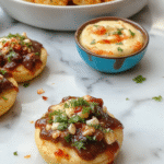 A vibrant assortment of colorful food bars arranged on a sleek table, featuring various sweet and savory options like fruit, cheese, nuts, chocolate, and crackers, styled with decorative garnishes and appetizing textures.